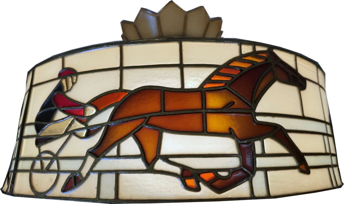 The Tiffany shade over the bar: a trotting horse and sulky worked in leaded glass