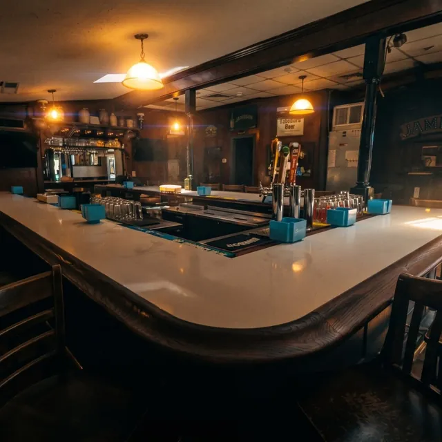 The long white-topped bar under the pendant lamps